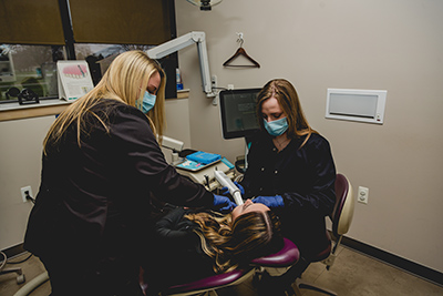 Our dental hygienists with a patient at Dental Smiles of Livonia