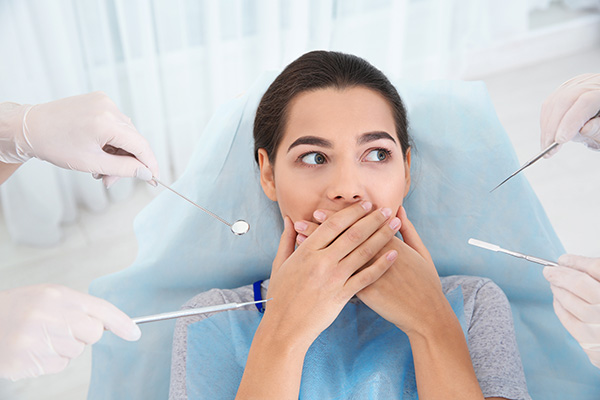 Young woman scared of dental examination